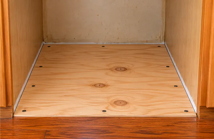 National Floors - Dishwasher Plywood Repair Three quarter inch plywood replacing water damaged particle board beneath dishwasher