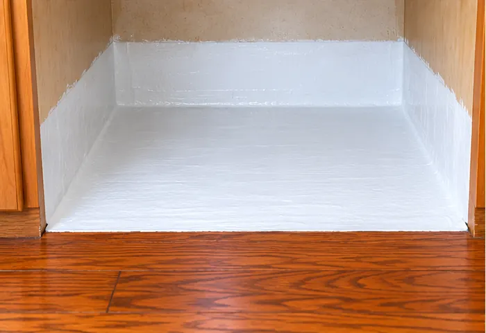 National Floors - White Flex Seal Dishwasher Moisture Barrier White Flex Seal moisture barrier applied beneath dishwasher and four inches up cabinet sides